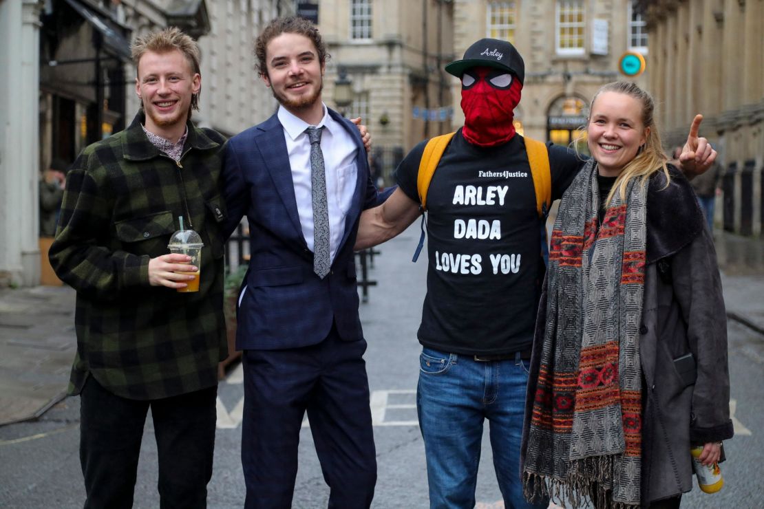 (L-R) Milo Ponsford, Sage Willoughby, Jake Skuse and Rhian Graham, collectively known as the "Colston 4," pose for a photograph outside Bristol Crown Court during the trial. 