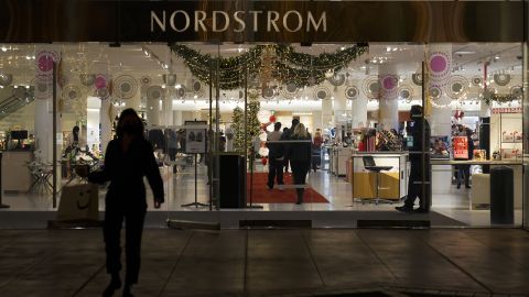 A security guard stands at the entrance to a Nordstrom store at The Grove mall in Los Angeles where a recent robbery took place. 