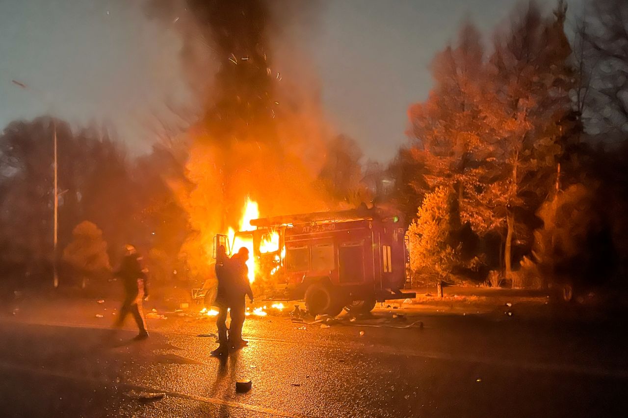 A burning car is seen close to the mayor's office in Almaty on January 5.