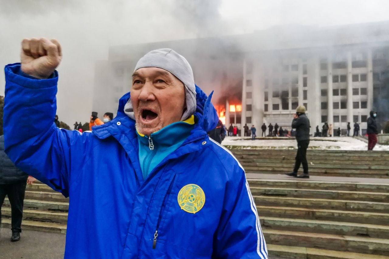 A man protests outside the burning mayor's office in Almaty on January 5.