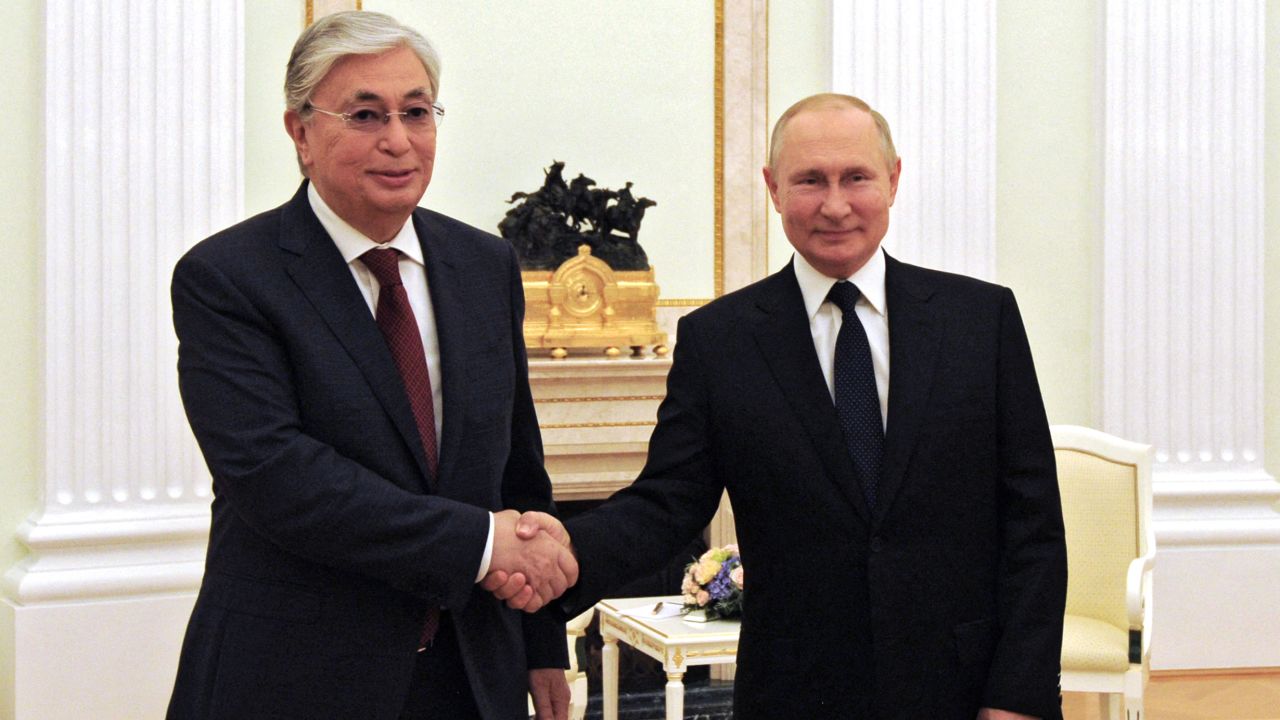 Putin (R) greets Kazakhstan's President Kassym-Jomart Tokayev in Moscow on August 21, 2021.