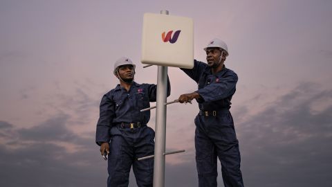 Workers install a World Mobile node as it constructs its land-air network.