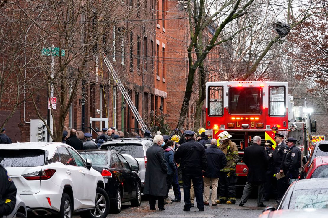 Philadelphia firefighters work at the scene of a deadly row house fire Wednesday in the neighborhood of Fairmount.