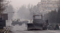 Servicemen and their military vehicles block a street in central Almaty on January 7, 2022, after violence that erupted following protests over hikes in fuel prices. 