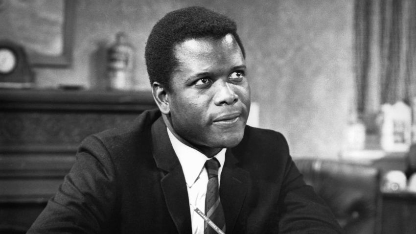 Sidney Poitier sitting with pencil while looking up in a scene from the film 'To Sir, With Love', 1967. (Photo by Columbia Pictures/Getty Images)