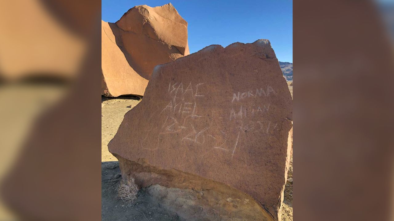 The ancient petroglyphs were defaced by visitors who scratched their names into the rock.