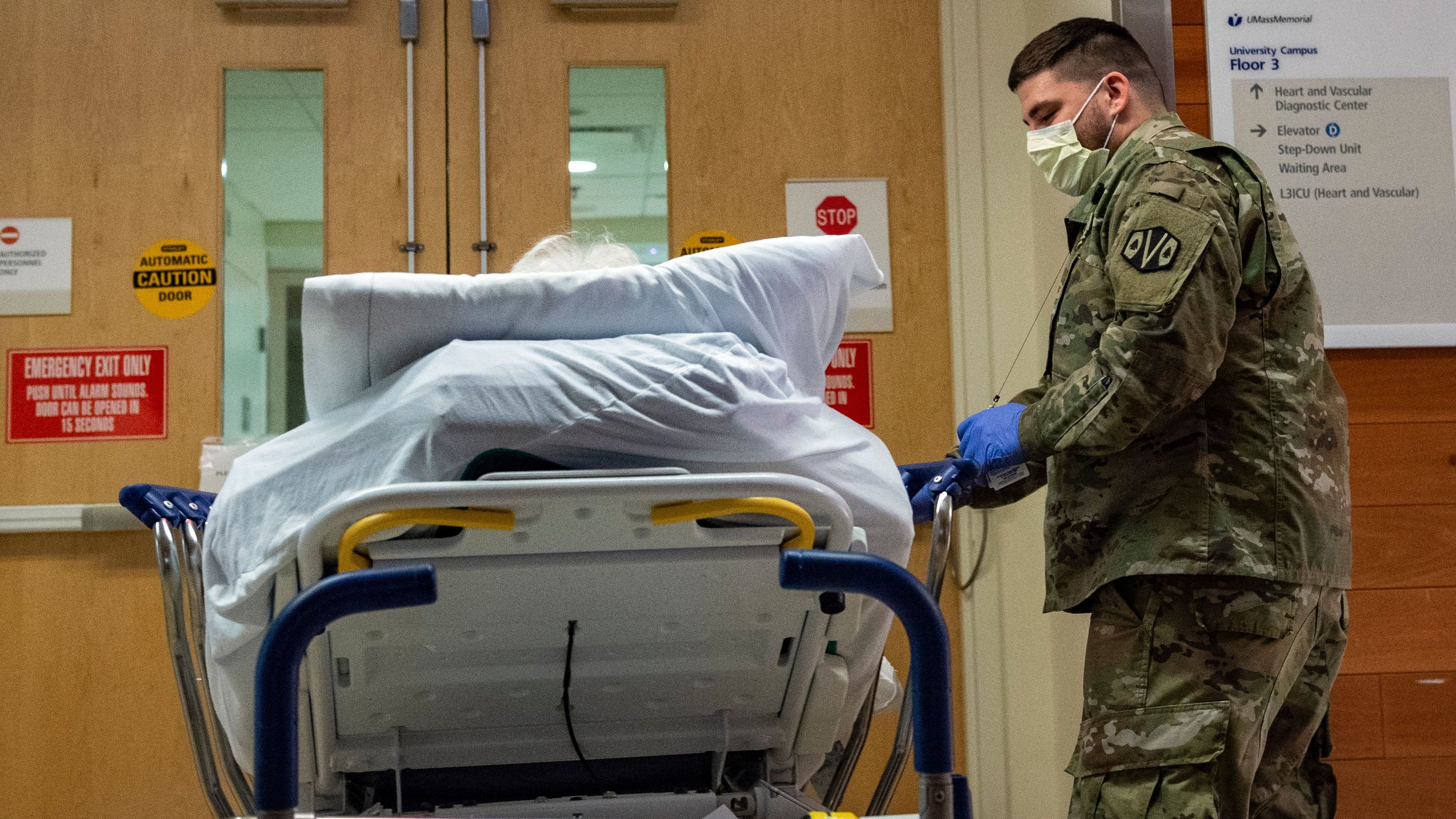 A soldier transports a patient at UMass Memorial Medical Center in Worcester, Massachusetts on December 30, 2021. 