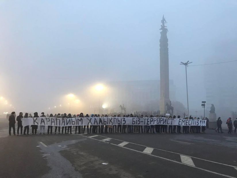 Protesters hold a long banner that reads "We are the people, not terrorists" at the Republic Square in Almaty on January 7. 