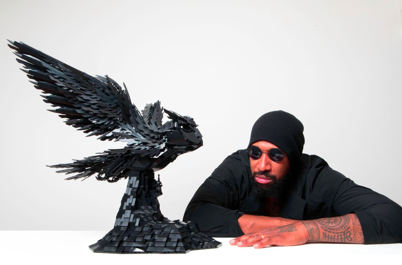 Nimako, pictured here next to his "Warrior Owl" sculpture, only uses black-colored Lego pieces.