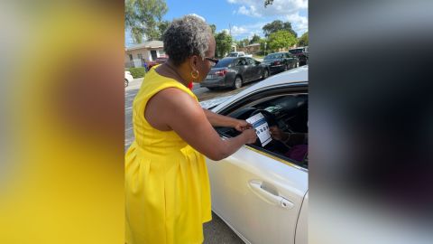 Epilepsy Florida navigator Renita Samuels-Dixon hands out fliers about Affordable Care Act enrollment.
