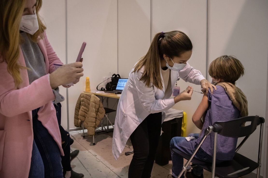 A health worker administers a Covid-19 shot to a child in Lisbon. Portugal, among the most highly vaccinated countries in the world, started rolling out shots to 5- to 11-year-olds in late December.