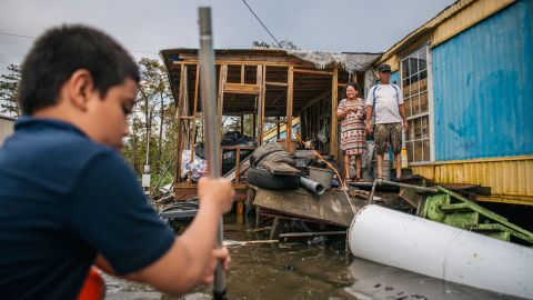 The Maldonado family travels by boat to their home after it flooded during Hurricane Ida on August 31, 2021, in Barataria, Louisiana.