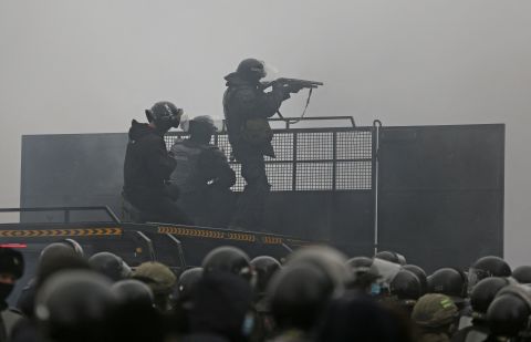Police officers are seen on a barricade in Almaty on January 5.