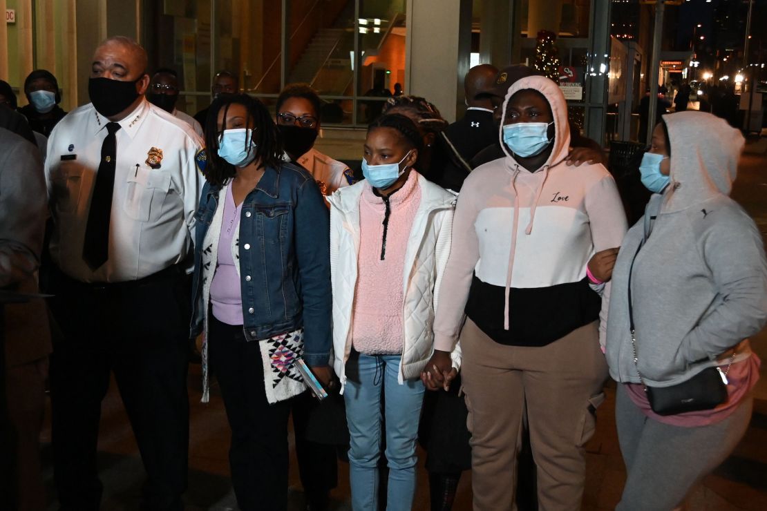 Baltimore Police Commissioner Michael Harrison, left, stands with the family of Keona Holley, a Baltimore police officer who died last month after an ambush attack.