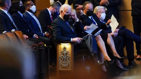 President Joe Biden wipes his eye as he attends a memorial service for former Senate Majority Leader Harry Reid with first lady Jill Biden, Vice President Kamala Harris and her husband Doug Emhoff at the Smith Center in Las Vegas, Saturday, Jan. 8, 2022. 