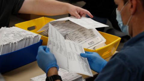 Election officials and volunteers process ballots for counting during the 2020 Presidential election in Provo, Utah.