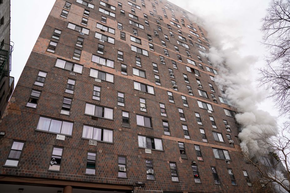 Smoke billows out of apartment windows from the fire.