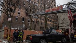 Emergency personnel work at the scene of a fatal fire at an apartment building in the Bronx on Sunday, Jan. 9, 2022.