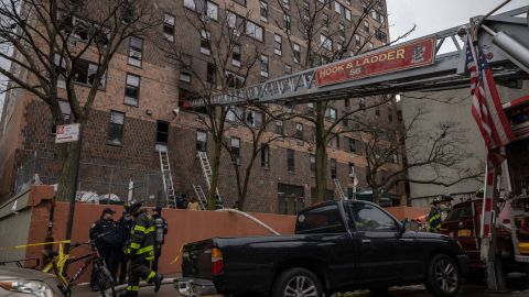 Emergency personnel work Sunday at the scene of the fatal Bronx fire.