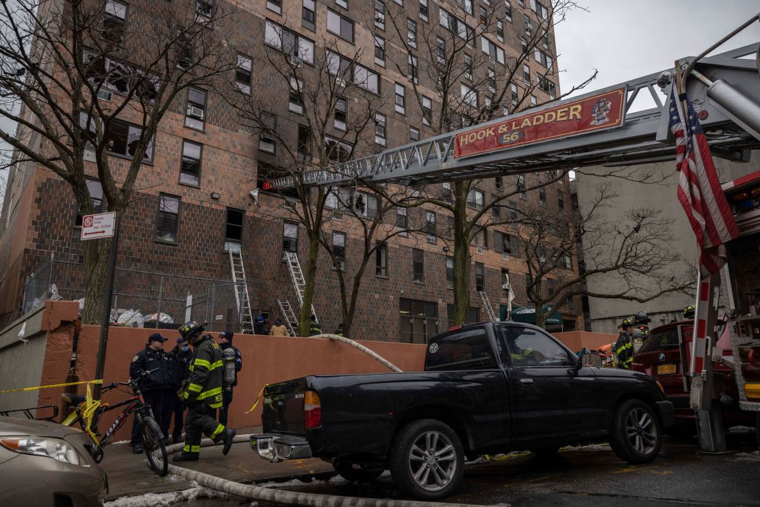 Emergency personnel work Sunday at the scene of the fatal Bronx fire.
