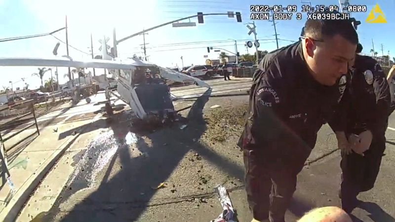 LAPD officers pull injured pilot from crashed plane moments before train slams into wreckage