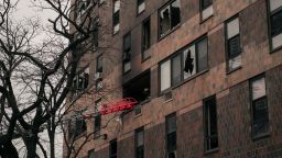 Broken windows and charred bricks mark the exterior of a 19-story residential building after a fire erupted in the morning on January 9, 2022 in the Bronx borough of New York City.