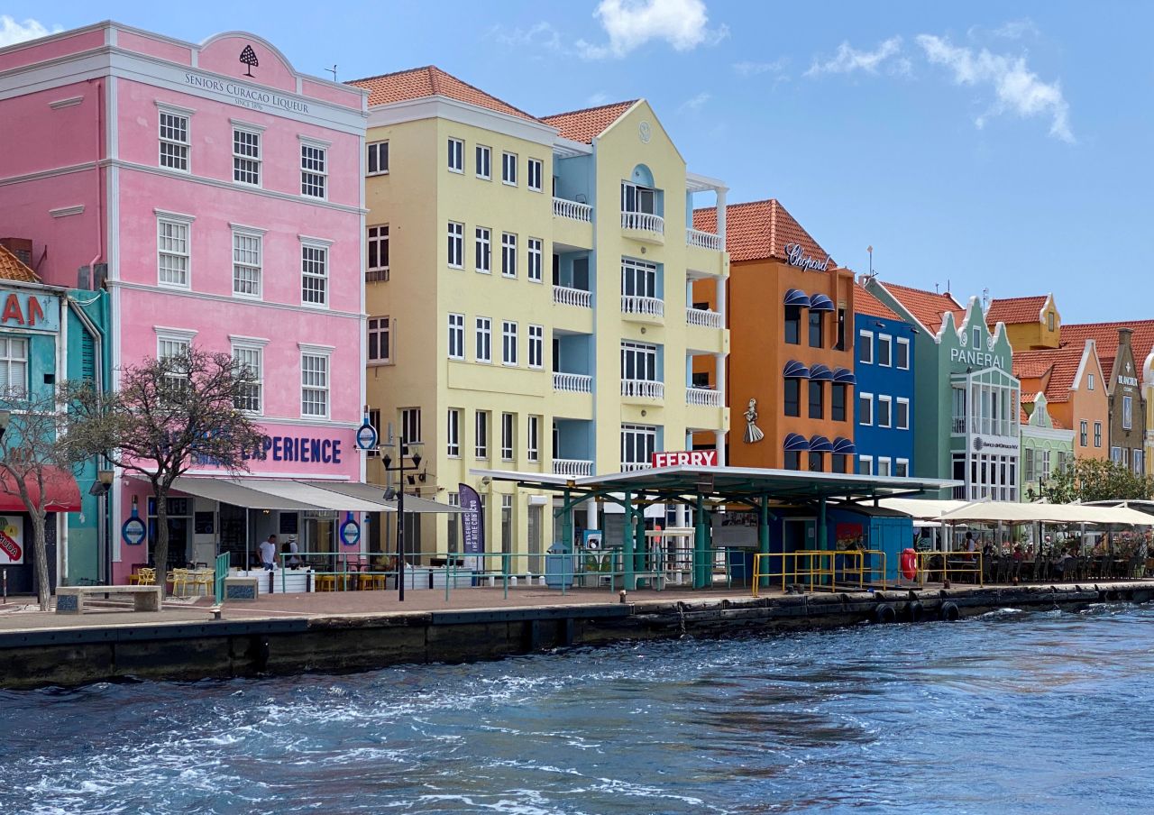 Pastel colored buildings line the waterfront of old town Willemstad, Curaçao. This Dutch island has been moved up to risk Level 4 by the CDC, joining 'ABC' sister islands Aruba and Bonaire.