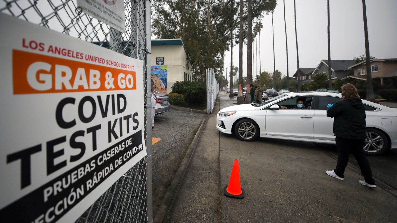 Los Angeles Unified School District staff distribute free Covid-19 test kits to local families on Friday, January 7, ahead of this week's return to school.
