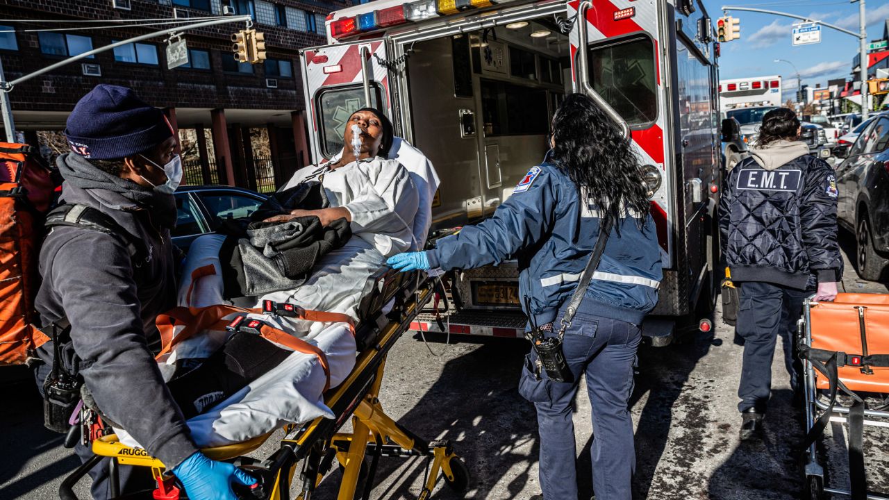 Outside a hotel temporarily housing the evacuated residents of a deadly fire, a woman suffering from asthma is taken to a hospital for treatment.