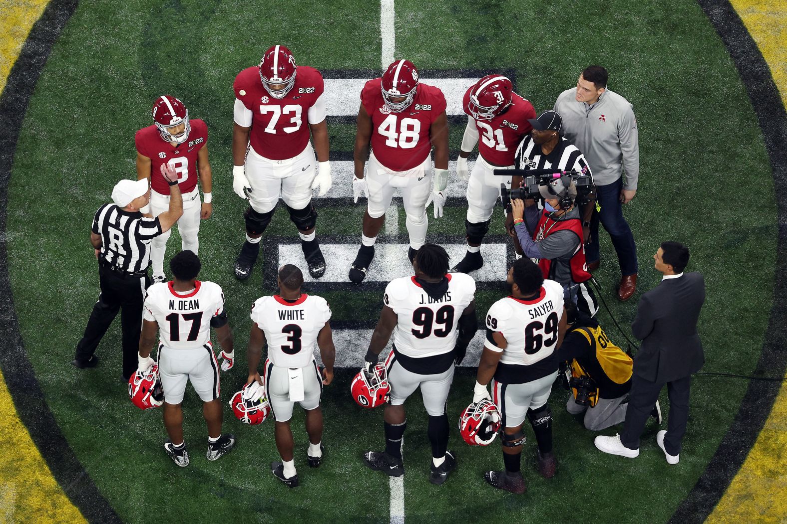 Team captains meet for the opening coin toss before kickoff.