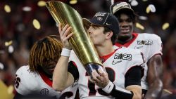 INDIANAPOLIS, INDIANA - JANUARY 10: Stetson Bennett #13 of the Georgia Bulldogs celebrates with the National Championship trophy after the Georgia Bulldogs defeated the Alabama Crimson Tide 33-18 during the 2022 CFP National Championship Game at Lucas Oil Stadium on January 10, 2022 in Indianapolis, Indiana. (Photo by Andy Lyons/Getty Images)