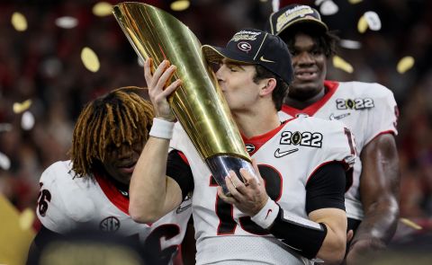 Georgia quarterback Stetson Bennett kisses the National Championship trophy after the Bulldogs defeated Alabama on Monday, January 10. Bennett is a former walk-on who grew up a Georgia fan.