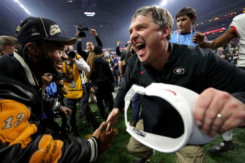 Georgia head coach Kirby Smart is congratulated by former Georgia running back D'Andre Swift during the postgame celebrations.