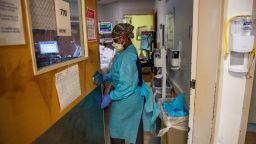 A medical worker enters a negative pressure room in PPE to work with a patient who has covid-19 in the ICU ward at UMass Memorial Medical Center in Worcester, Massachusetts on January 4, 2022.