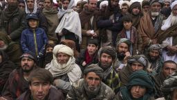 FILE - Hundreds of Afghan men gather to apply for the humanitarian aid in Qala-e-Naw, Afghanistan, Tuesday, Dec. 14, 2021. In a statement Tuesday, Jan. 11, 2022, the White House announced $308 million in additional humanitarian assistance for Afghanistan, offering new aid to the country as it edges toward a humanitarian crisis since the Taliban takeover nearly five months earlier. (AP Photo/Mstyslav Chernov, File)