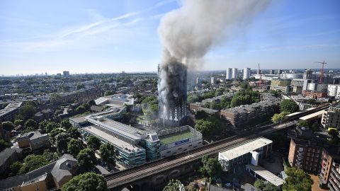 LONDON, ENGLAND - JUNE 14:  Smoke rises from the building after a huge fire engulfed the 24 storey residential Grenfell Tower block in Latimer Road, West London in the early hours of this morning on June 14, 2017 in London, England.  The Mayor of London, Sadiq Khan, has declared the fire a major incident as more than 200 firefighters are still tackling the blaze while at least 50 people are receiving hospital treatment.  (Photo by Leon Neal/Getty Images)