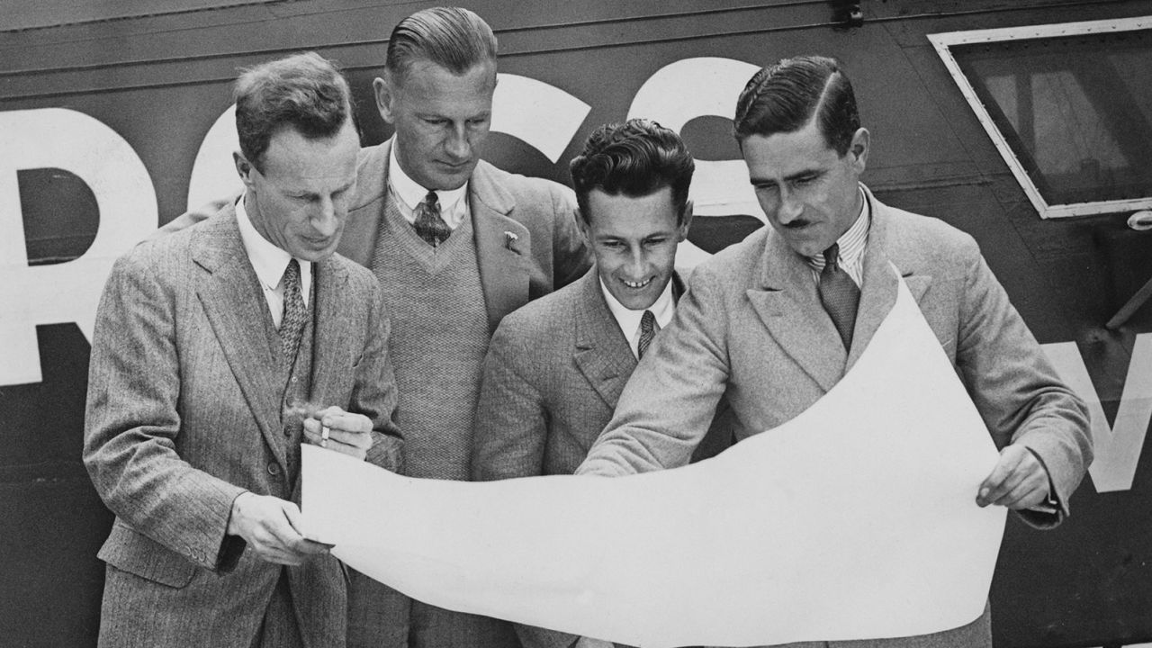 The four-man crew of the Southern Cross monoplane study a map of their route at Croydon airport in June 1930. Left to right: Australian aviator Charles Kingsford Smith, co-pilot Evert Van Dyke, radio operator John Stannage and navigator J. Patrick Saul. 