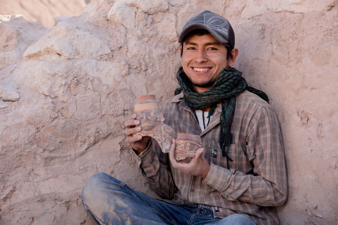 Maico Aybar Villalobos holds fragments of a Robles Moqo vessel that he excavated from Quilcapampa.