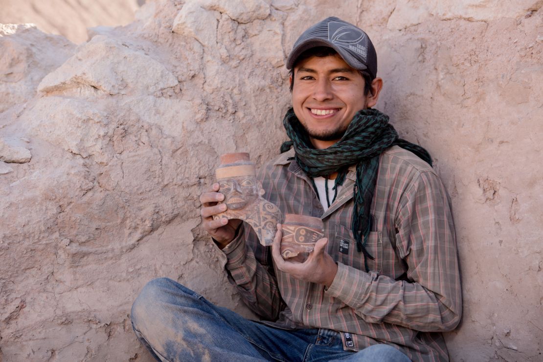 Maico Aybar Villalobos holds fragments of a Robles Moqo vessel that he excavated from Quilcapampa. 