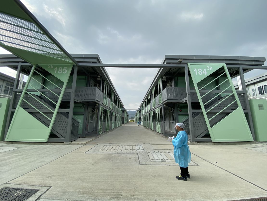 A staff member stands outside buildings of Hong Kong's government quarantine center at Penny's Bay.
