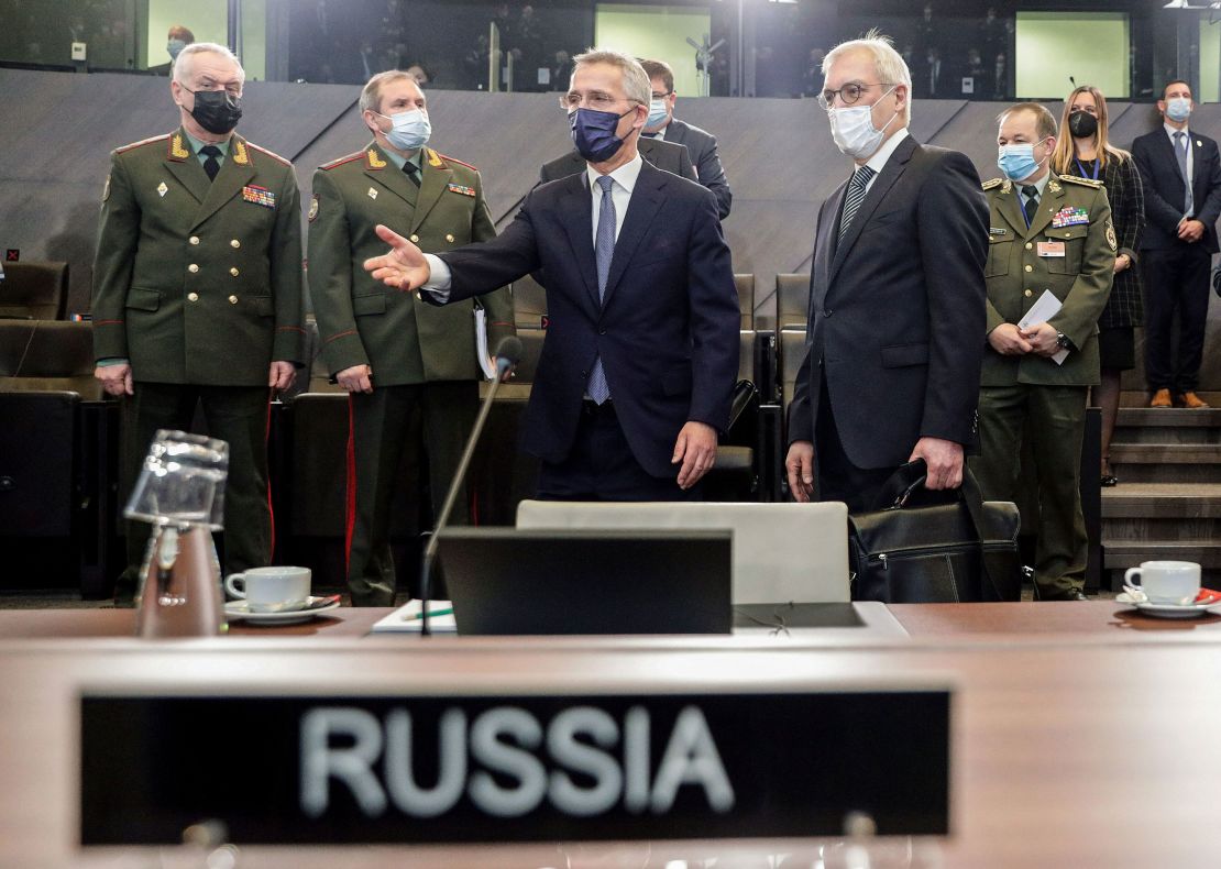 Russian Deputy Foreign Minister Alexander Grushko, right, and NATO Secretary General Jens Stoltenberg, center, arrive at the NATO-Russia Council at the Alliance's headquarters in Brussels, on January 12, 2022. 