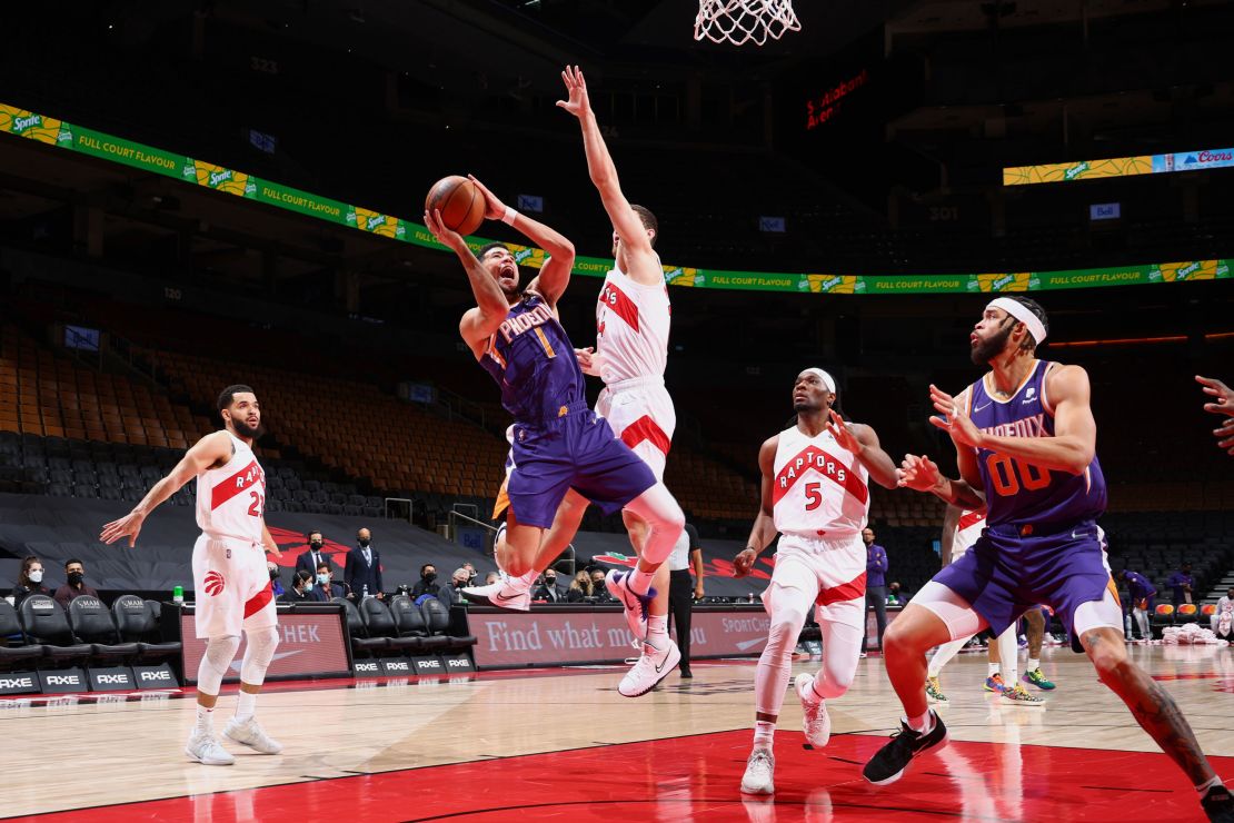 Booker shoots during the game.