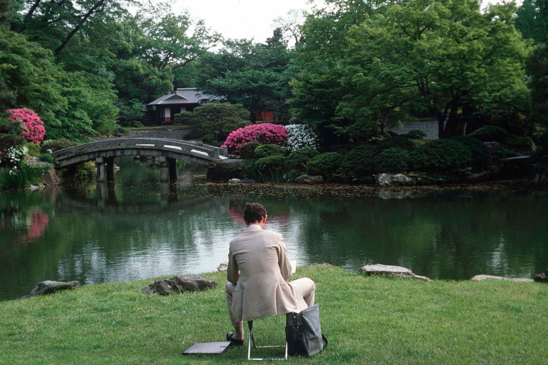 During a royal tour of Japan, Prince Charles sits to paint a watercolor in the garden of the Imperial Palace In Kyoto.