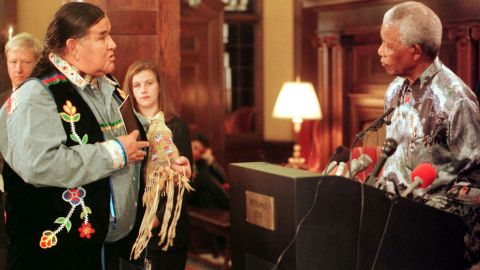 Former South African President Nelson Mandela is pictured in 2000 listening to Clyde Bellecourt make an appeal for the case of Leonard Peltier, whom AIM said had been wrongly imprisoned.