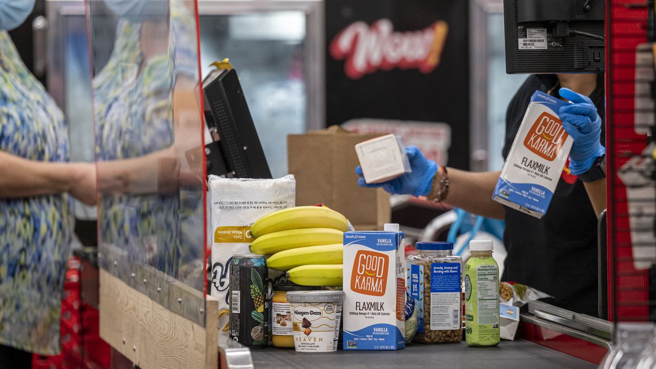 A customer checks out at a grocery store in San Francisco, California, U.S., on Thursday, Nov. 11, 2021.