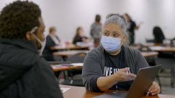 Maria Torres, a navigator with the United Way of Metropolitan Dallas, helps a client sign up for Affordable Care Act coverage.