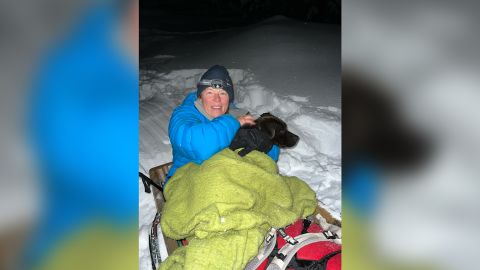 Leona Allen and Russ wrapped in blankets as they descended on a sled down the snowy hill.