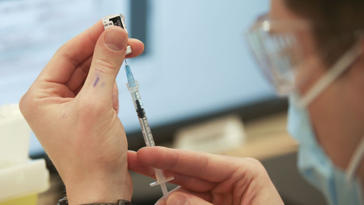 A health care worker in Montreal prepares a dose of the Pfizer/BioNTech Covid-19 vaccine in March 2021.