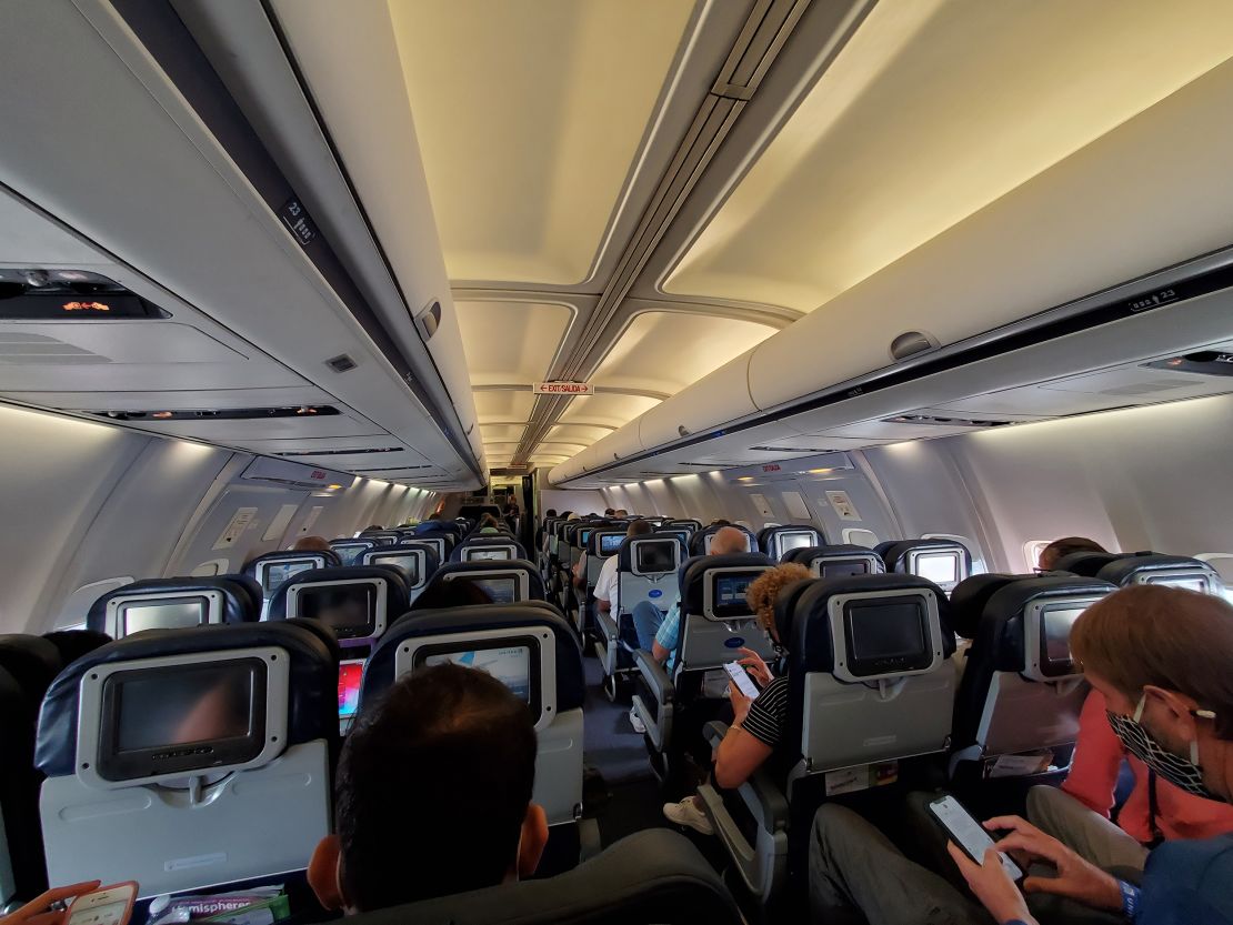Passengers aboard a United Airlines airplane during a flight in July 2021