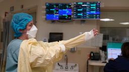FILE - A nurse suits up with protective gear before entering a patient's room at the COVID-19 Intensive Care Unit at Dartmouth-Hitchcock Medical Center, in Lebanon, N.H., Jan. 3, 2022. The omicron variant has caused a surge of new cases of COVID-19 in the U.S. and many hospitals are not only swamped with cases but severely shorthanded because of so many employees out with COVID-19. (AP Photo/Steven Senne, File)